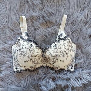 Elegant cream embroidered floral lace bra with black trim